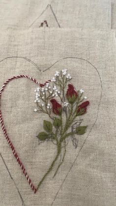 a heart - shaped piece of fabric with flowers on it