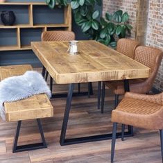 a wooden table and chairs in a room