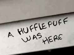 a white sign with black writing on it that says a hufflepuff was here