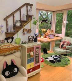 a living room filled with furniture and lots of clutter on the floor next to a window