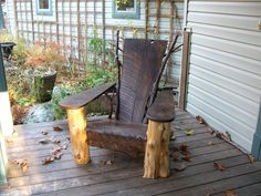 a wooden chair sitting on top of a wooden deck next to a tree stump bench