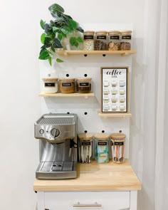 a coffee maker sitting on top of a counter next to shelves filled with spices and condiments