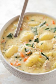 a close up of a bowl of food with broccoli and dumplings in it