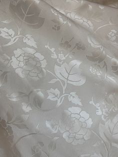 the fabric is white and has flowers on it