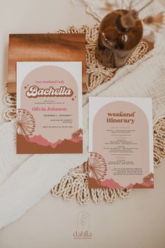 the wedding stationery is laid out on top of a blanket and some other items