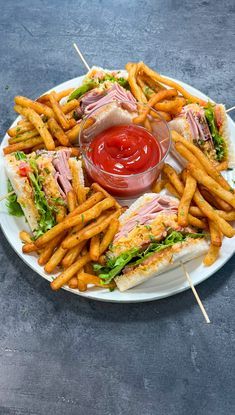 a sandwich and french fries on a plate with ketchup