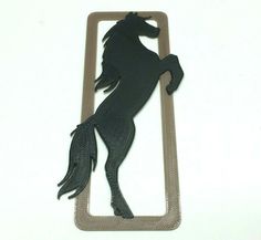 a black horse is standing on its hind legs in the shape of a rectangle