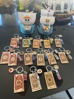 a table topped with lots of wooden key chains and tags next to eachother