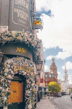 a building with flowers growing on the side of it