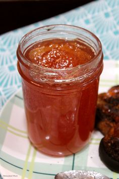 a jar of jam sitting on top of a plate