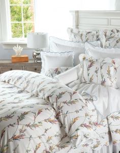 the comforter is white and has birds on it