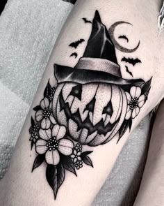 a black and white image of a pumpkin with a witches hat on it