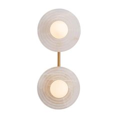 two lights that are on the side of a wall mounted light fixture in white marble