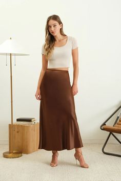 Our Vivian Satin Column Skirt is the perfect blend of elegance and comfort. Featuring a high waist and elasticized waistband, this A-line slip midi skirt is both stylish and functional. The satin texture adds a touch of luxury, while the solid color allows for endless styling options. Get ready to turn heads in this must-have piece. We always suggest ordering your true size. Material: 98% Polyester, 2% Spandex Midi Skirt Satin, Slip Midi Skirt, Skirt Satin, Satin Texture, Kimono Sweater, Column Skirt, Copper Key, Satin Midi Skirt, Satin Slip