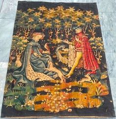 an old tapestry with two women sitting on the ground in front of trees and flowers