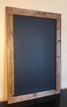 a blackboard mounted to the side of a fireplace