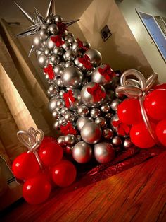 a christmas tree made out of silver and red balls