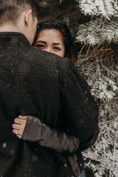 a man and woman embracing in the snow