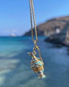 Please be advised that this order is MADE TO ORDER. Please allow 6-8 weeks for production. Channel your inner ancient Greek Goddess with these handcrafted pendants.  Handcrafted of solid 14 karat solid gold, this pendant features a Grecian vase with baked enamel blue & white finishes and filigree work.  Attached to a 20 inch curb link cabin.  Weighs 7 grams.  Measures just over one inch long. The Grecian Vase or Amphora is typically a one or two handled vessel used to transport olive oil and win Handmade 14k Gold Amulet Necklace, Unique Yellow Gold Necklace For Ceremonial Use, Artisan Engraved Yellow Gold Necklace, Ceremonial 14k Stamped Pendant Jewelry, Artisan Yellow Gold Collectible Jewelry, Ceremonial 14k Gold Hallmarked Necklaces, Ceremonial Handmade Yellow Gold Necklace, Ceremonial Artisan Yellow Gold Jewelry, Luxury Handmade 14k Gold Necklaces