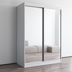 an empty room with mirrored doors and a couch in the corner on the far side