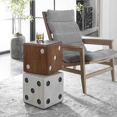 a chair sitting on top of a wooden block next to a table with a dice on it