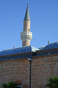 a large brick building with a clock tower in the middle of it's roof