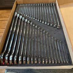 a box filled with lots of wrenches on top of a table