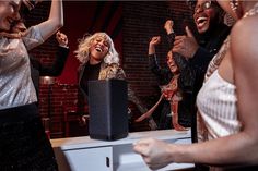 a group of women singing and dancing together