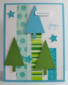 a handmade christmas card with trees and stars on the front, which reads season of joy