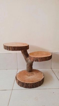 two wooden stools sitting on top of a white tile floor