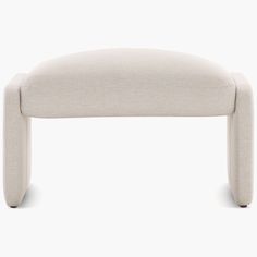 an upholstered foot stool with no legs on the top and bottom, in white fabric