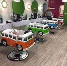 several vw campers are lined up on the floor in a barbershop