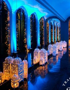 an indoor wedding venue with blue lighting and lanterns