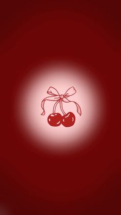 two cherries tied together with a bow on a red background in the middle of an image