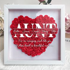 a heart shaped frame with roses in it