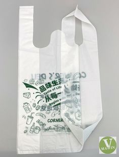 two white bags with green and white designs on the front, one has a tag that says corner