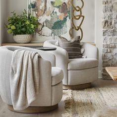 a living room filled with furniture and a painting on the wall above it's fireplace