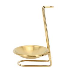 a gold plate with a metal holder on the side and a handle for it to hold something