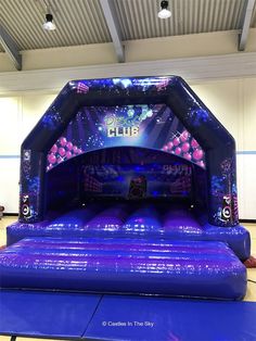 an inflatable bouncer with lights and music on the front is set up for a party