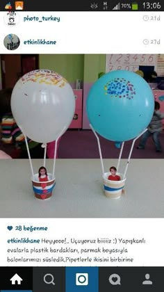 two hot air balloons sitting on top of each other in front of a child's room