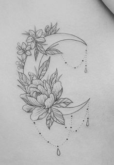 the back of a woman's stomach with flowers and crescent moon tattoo on it