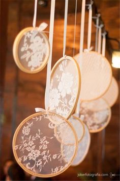 some white and gold plates hanging from a ceiling with lights in the backround