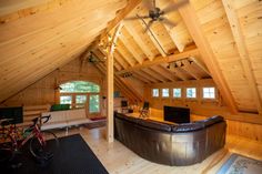 a living room filled with furniture and a flat screen tv on top of a wooden wall