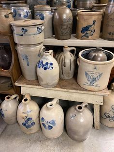 an assortment of vases and jars are on display