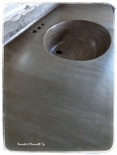 a sink with holes in the floor and water running from it's drain hole