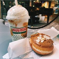 a doughnut and drink sitting on a table