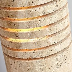 a close up of a light that is on top of a stone structure with many circles around it