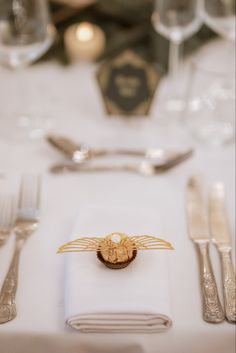 a white table topped with silverware and napkins