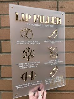 a sign that says lip filler aftercare advice on the side of a brick wall