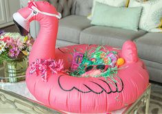 an inflatable flamingo is sitting on a coffee table